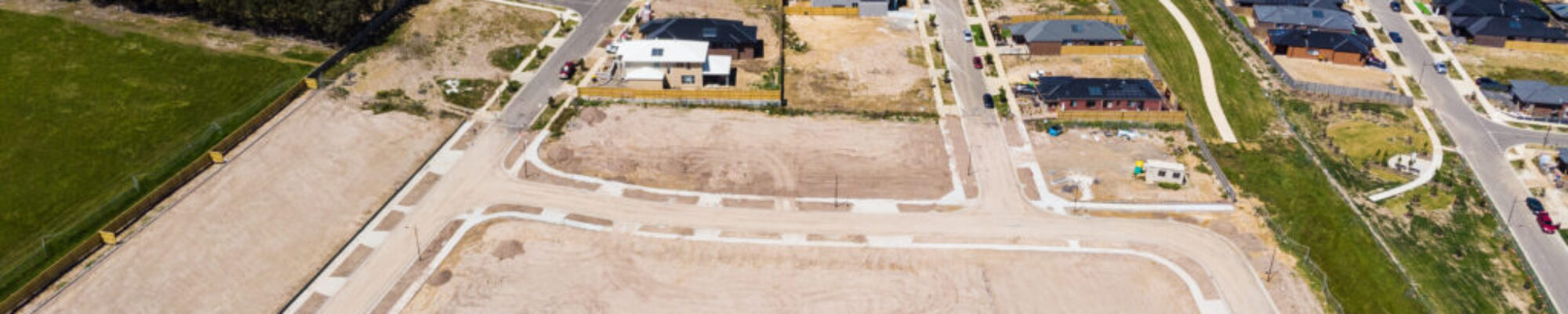 Aerial shots of a developing housing estate in the outer suburbs of Melbourne Australia, roads and gutters have been built, plots of land some already sold are almost ready for houses to be built. Aerial shots of a developing housing estate in the outer suburbs of Melbourne Australia, roads and gutters have been built, plots of land some already sold are almost ready for houses to be built.
